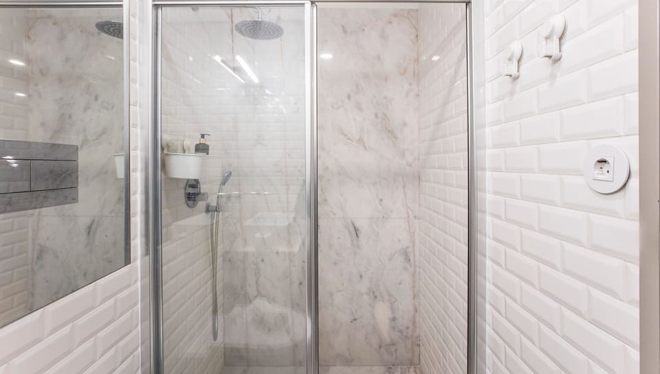 Step into this pristine shower, where sleek marble-effect tiles and a refreshing rainfall head await to rejuvenate your senses.
#Bathroom #RainfallShower #LovelyStay