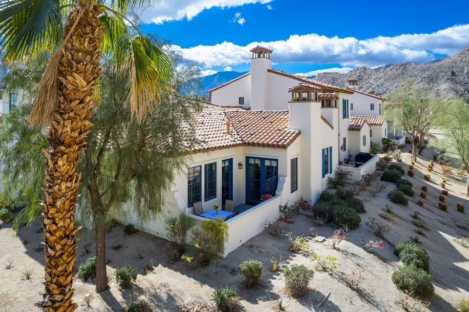 Rear patio has full 180-degree view of mountain, with BBQ and outdoor seating.
