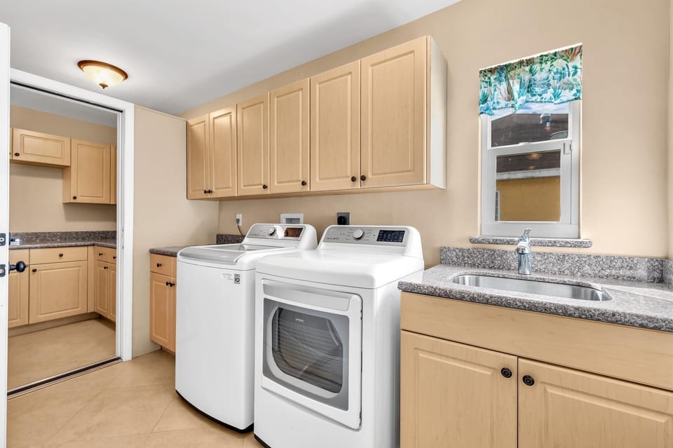 Spacious laundry area with full-size washer, dryer, and folding space!