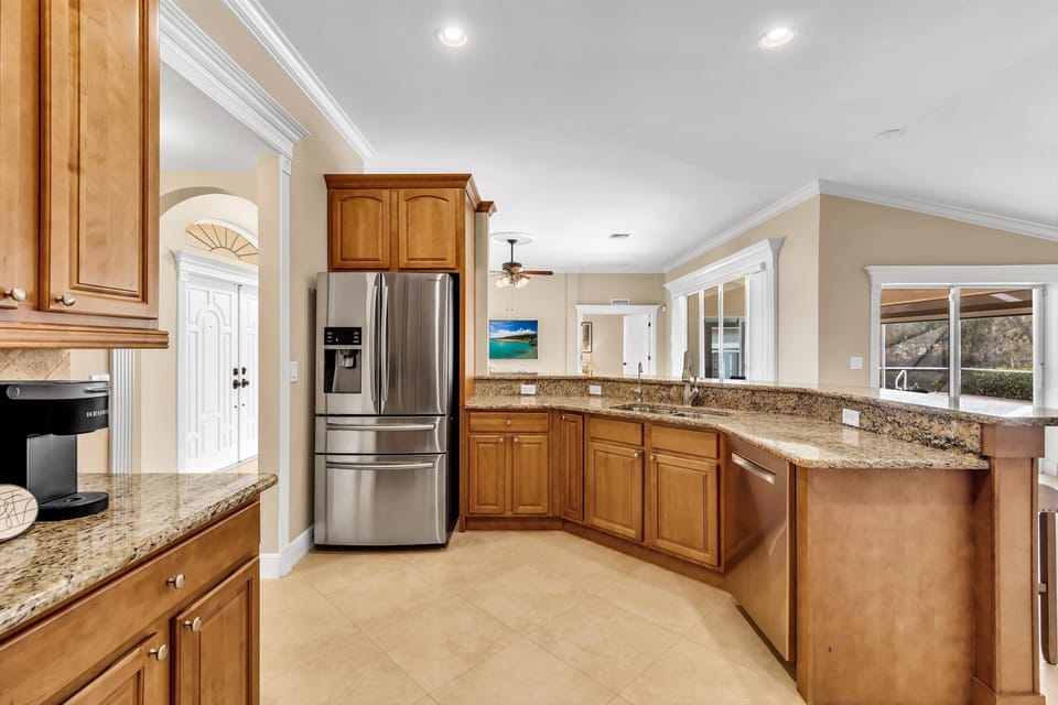 Spacious kitchen with a perfect view of the living room and your private pool. 