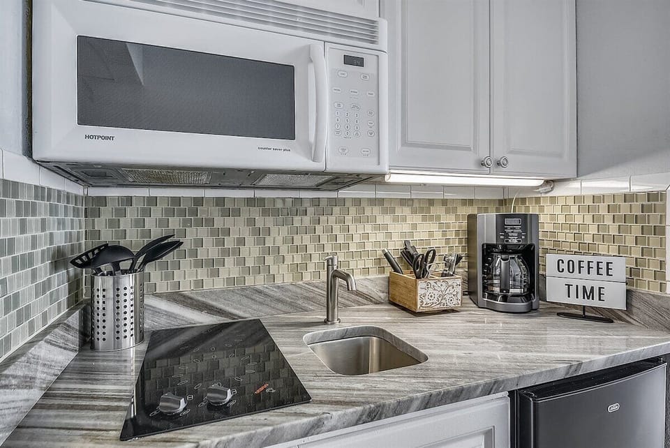 A compact kitchenette for preparing light meals and easy morning coffee.