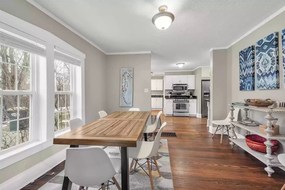 Dining room, with kitchen in background- seating for 10 (8 w/ "extra space")