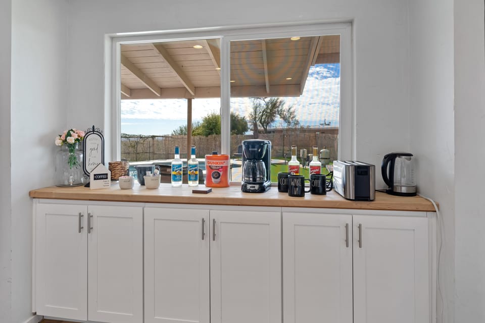Coffee bar with coffee, cream, sugars teas, syrups and electric kettle