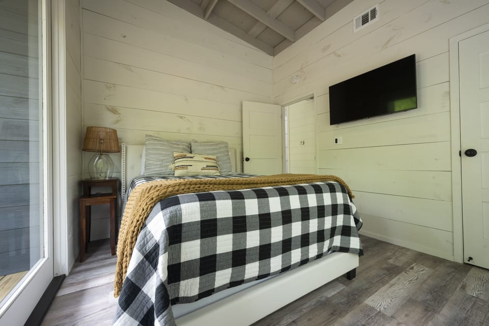 Queen room with french doors to deck/patio. 