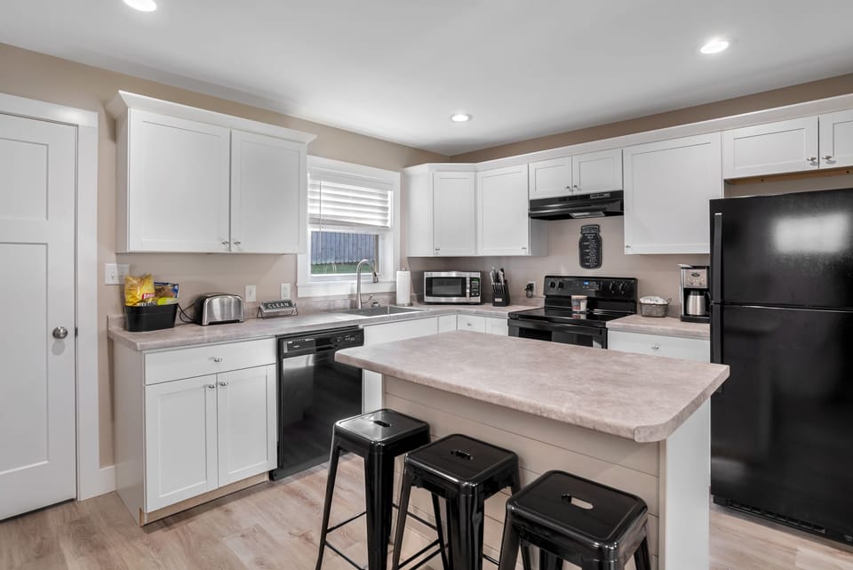 New fully stocked kitchen with microwave, toaster, blender & coffee maker.