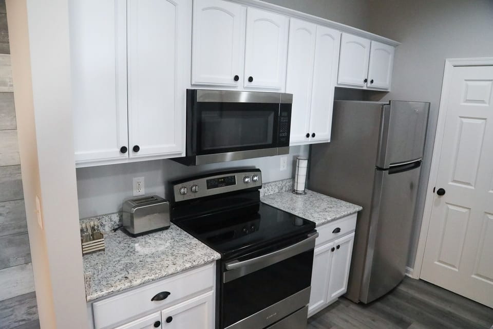 Galley kitchen with place settings for 4, plus 2 sets of kids plates. 