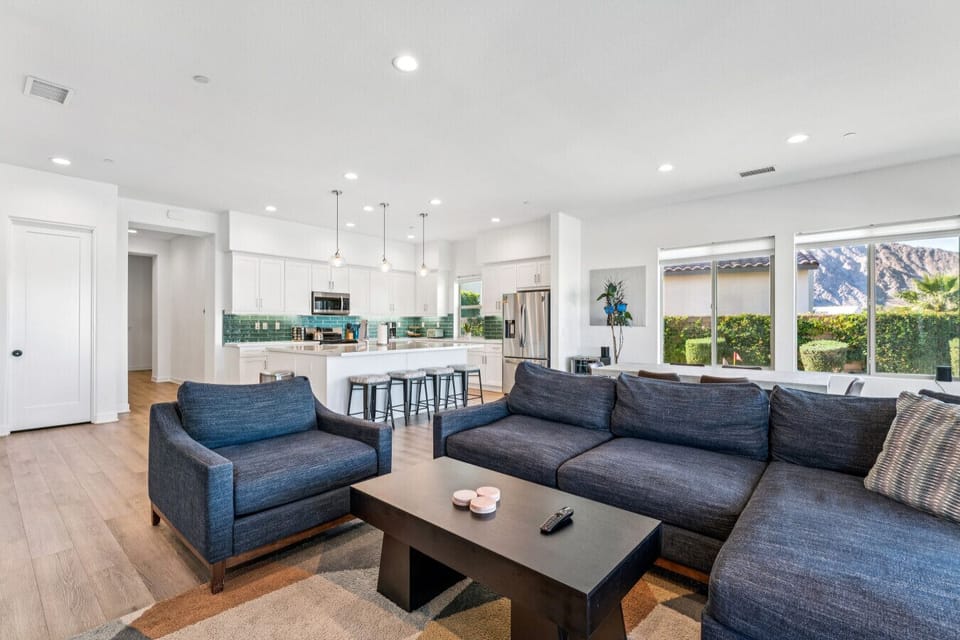 Open-concept living & kitchen area w/ cozy seating and modern finishes throughout