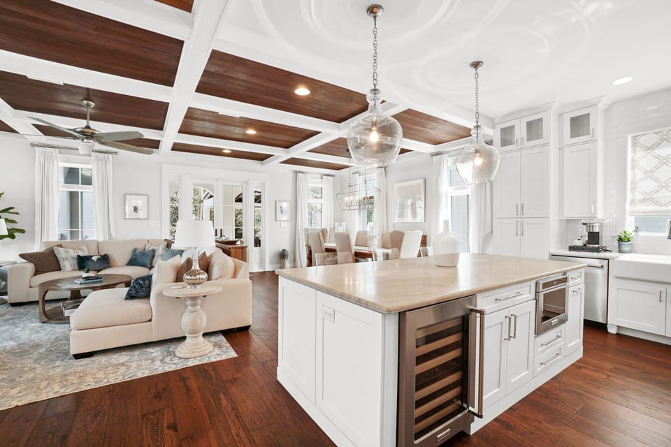 Your open-concept haven blends kitchen, dining, and living spaces under stunning wood-beam ceilings—perfect for memorable gatherings.