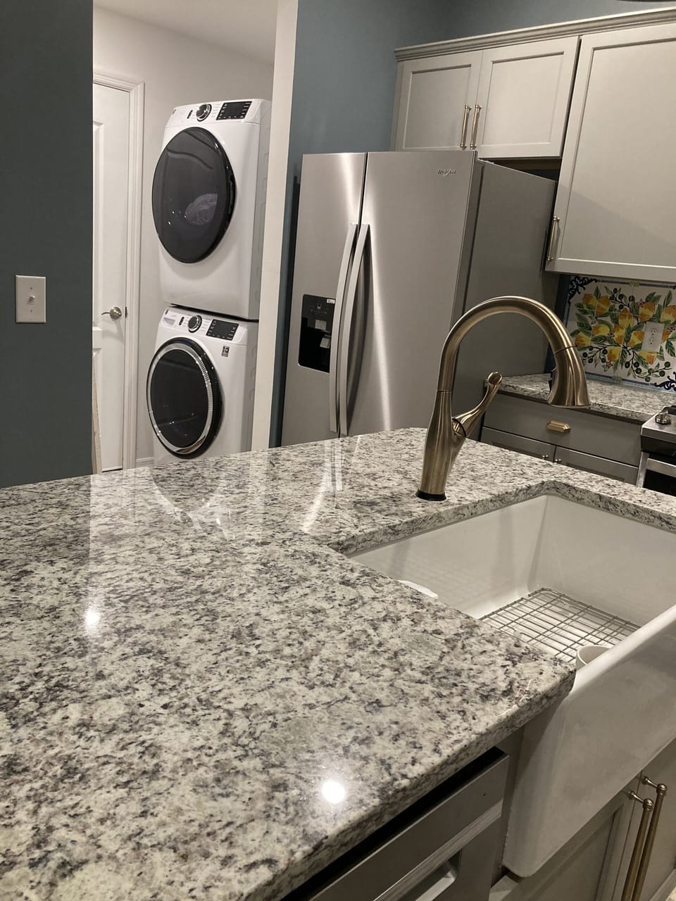 ISLAND FARM SINK ,  DELTA FAUCET WITH TOUCHLESS TECH.  WASHER DRYER 

