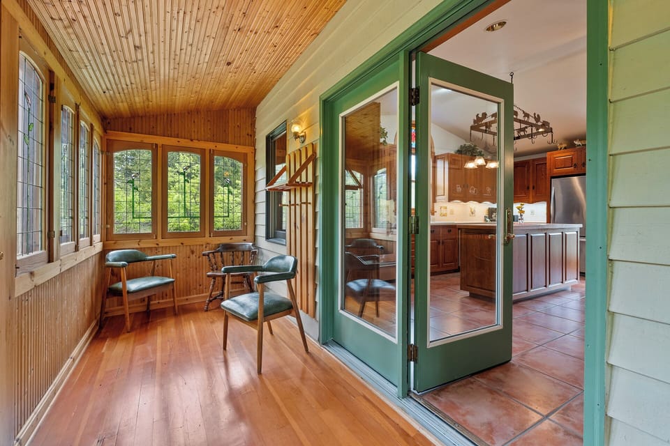 Three season porch with hand crafted stained glass made by the owner's father