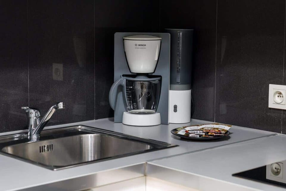 Functional kitchen with a coffee maker and cooking essentials.
