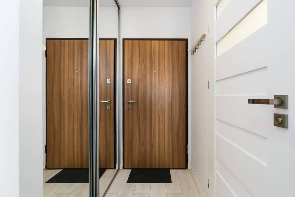 Spacious hallway in the apartment with stylish wooden accents.
