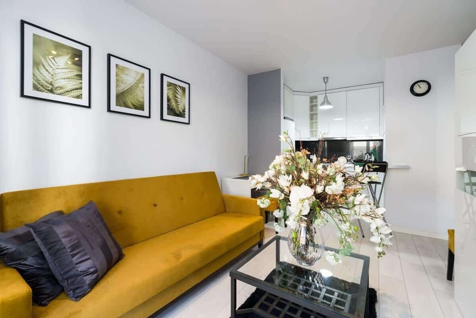 Stylish living room with floral centerpiece and yellow accents.
