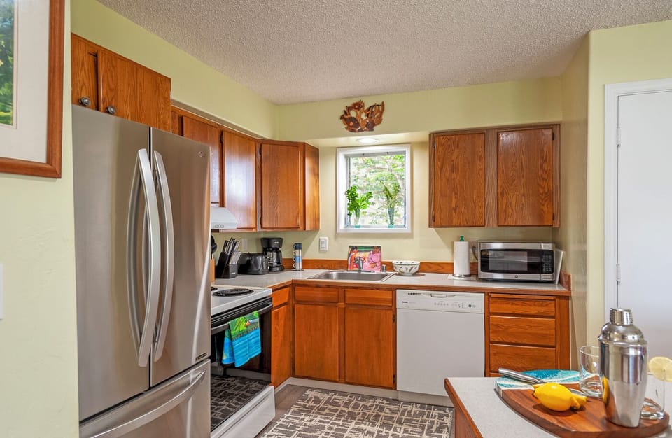 Alii Kai 1201 Princeville Vacation Condo - Enjoy a fully stocked kitchen: full size fridge/freezer, microwave, toaster, dishwasher, stove, pots and pans, salt and pepper, dishes and utensils, drip coffee maker, and stovetop kettle.
