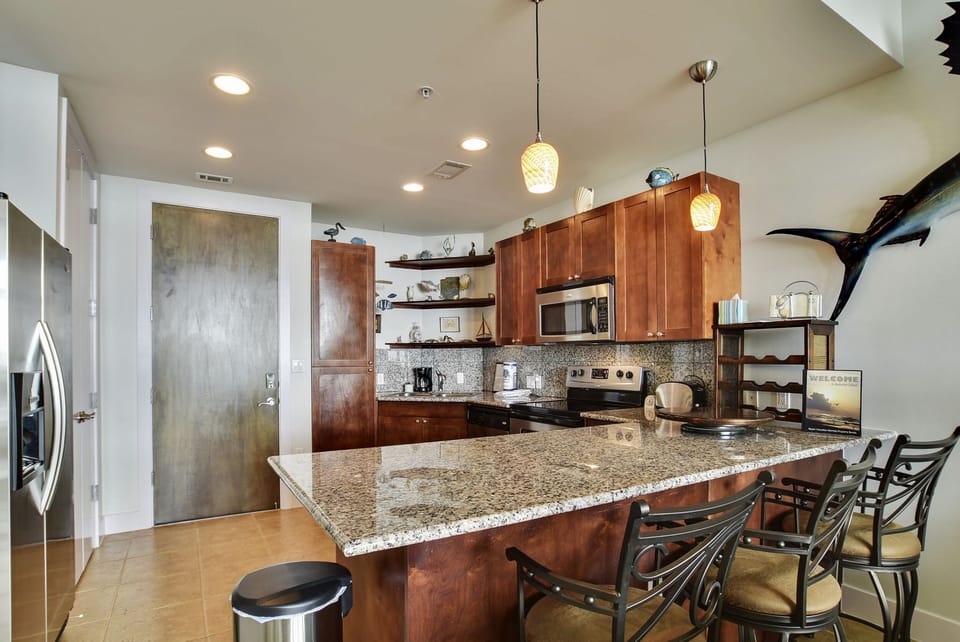 Granite countertops - Even if you aren't a gourmet chef, you will feel like one when you use this kitchen! Granite countertops, wooden cabinetry, a breakfast bar, and so much more.