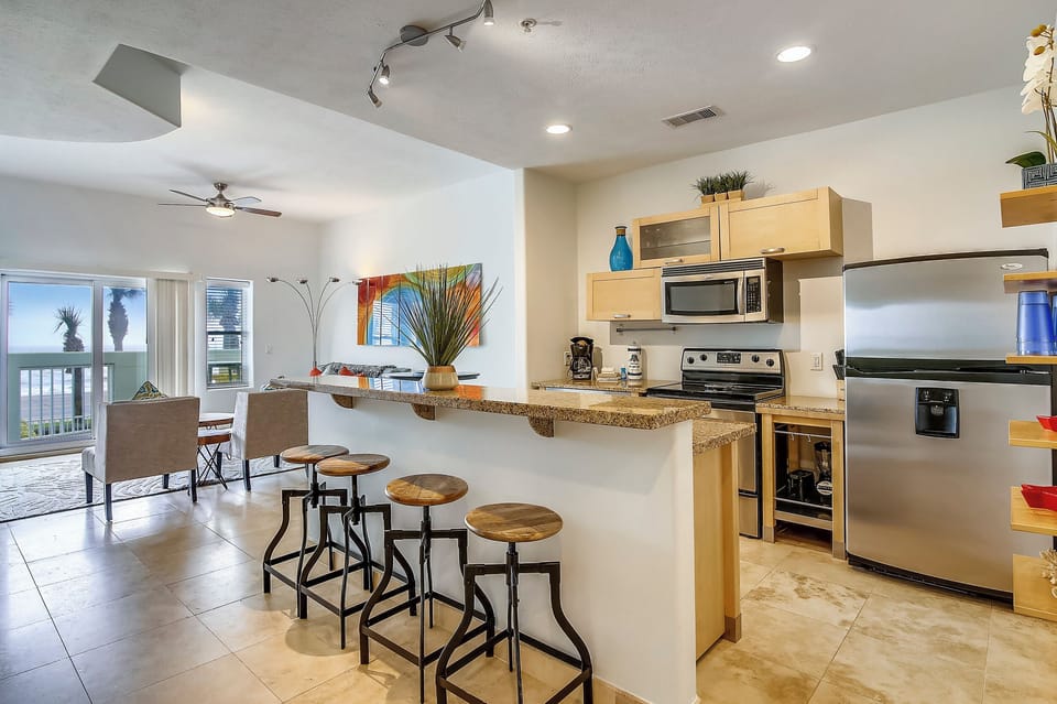 Spacious Breakfast Bar - Convenient and breezy, the kitchen accommodates several cooks. Use the long counter as extra eating space or as a buffet table for those big meals!