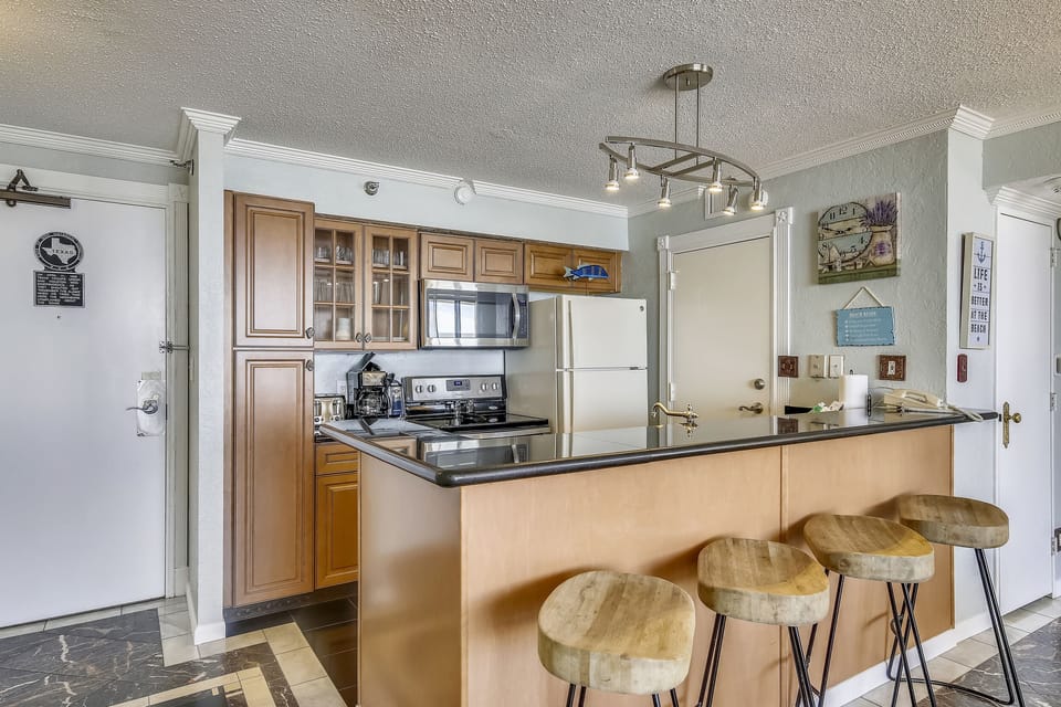Spacious Breakfast Bar - Convenient and breezy, the kitchen accommodates several cooks. Use the long counter as extra eating space or as a buffet table for those big meals!