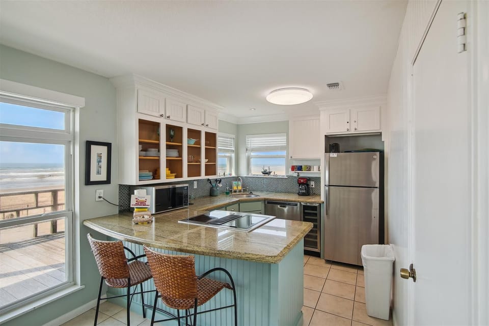 A Fully Loaded Kitchen -  With this full spread of a refrigerator, stove, and utensils, you'll have everything you need for the gourmet.