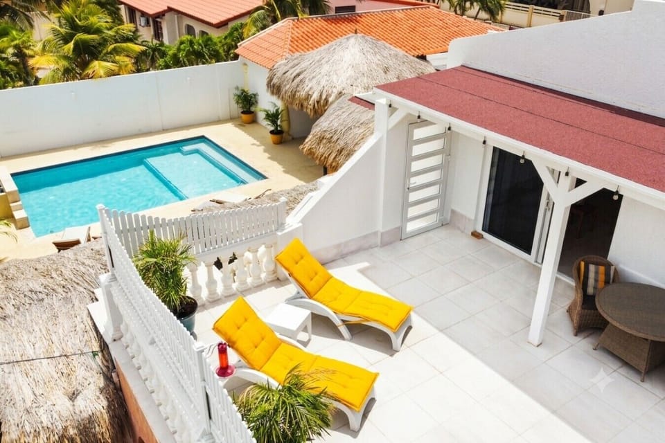 Grab your morning coffee or a favorite book and claim your spot on the sun loungers. This balcony gives you a front-row view of the sparkling pool below.