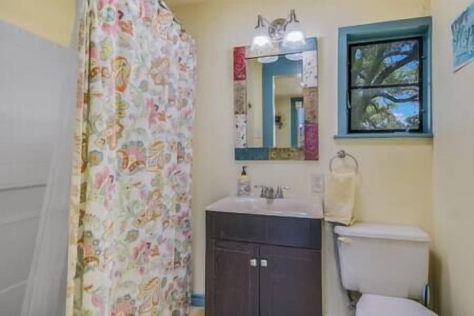 Full bath features and tub/shower combo, vanity and toilet 