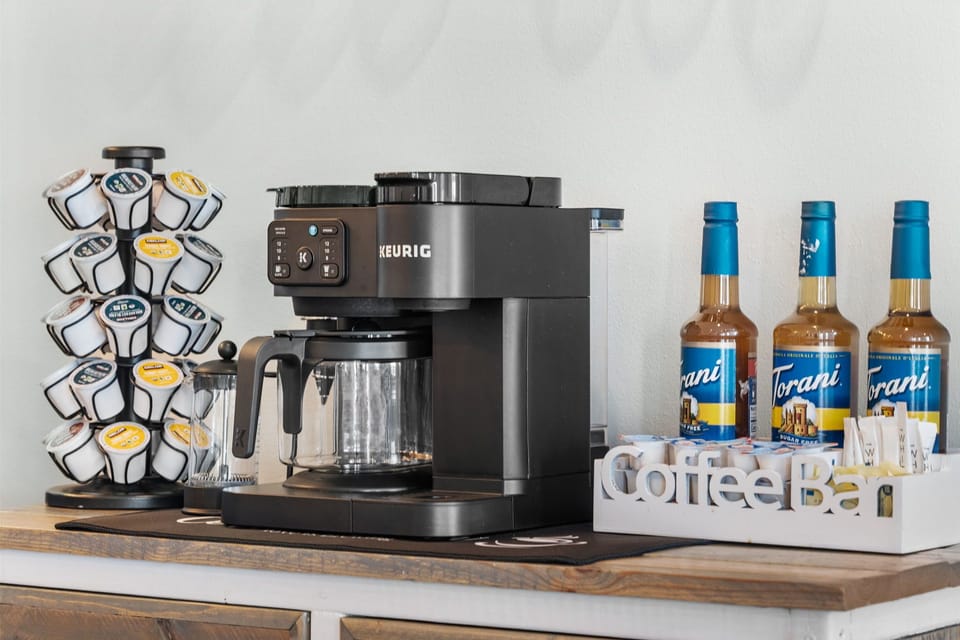 A fully stocked coffee bar greets all guests 24/7 with syrups. Kcups, sugar and creamer