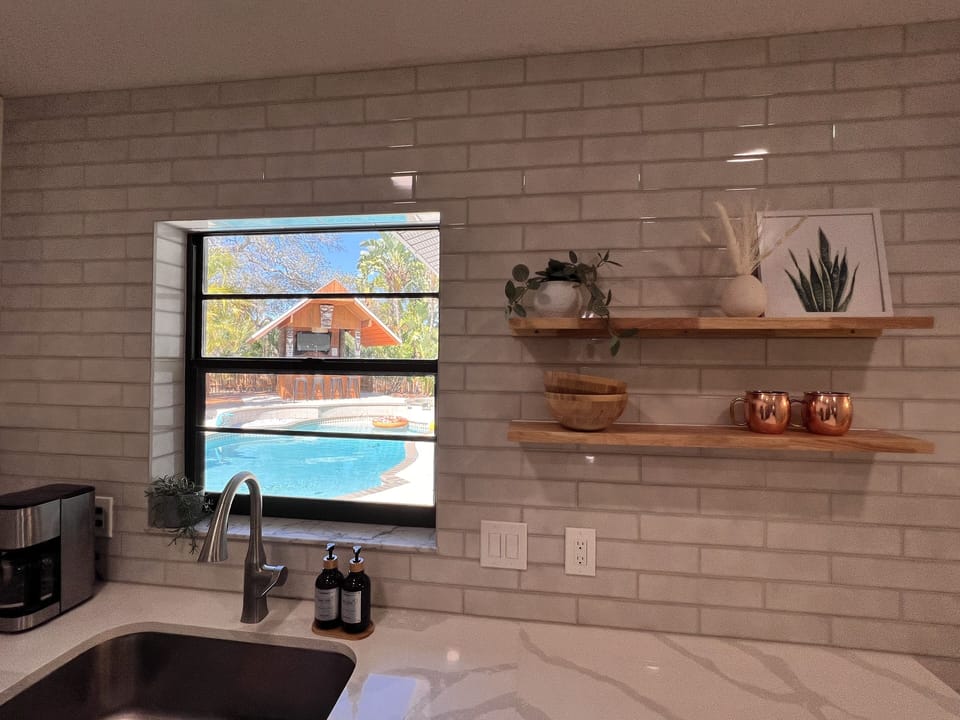 View of the pool/ back yard from the kitchen 