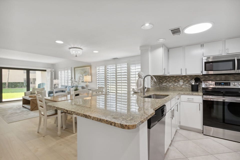 Fully Equipped Kitchen with Stunning Granite Countertops, Stainless Steel Appliances and Bar Stool Seating for Two