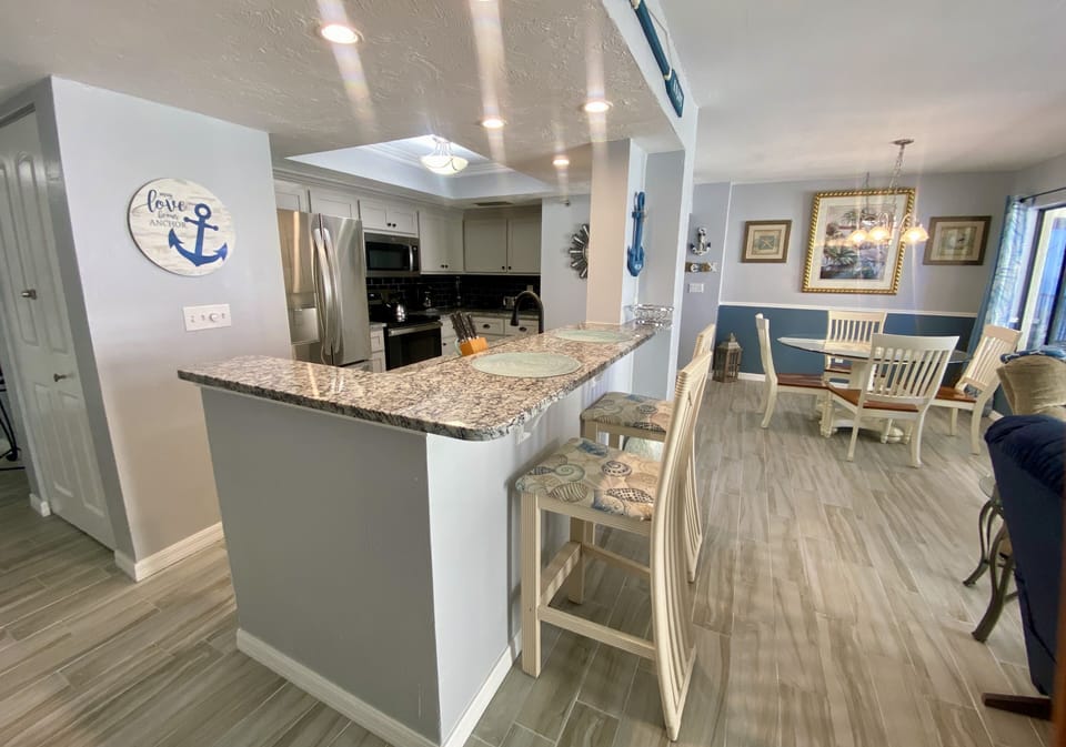 Open kitchen with breakfast bar and seating for two.  