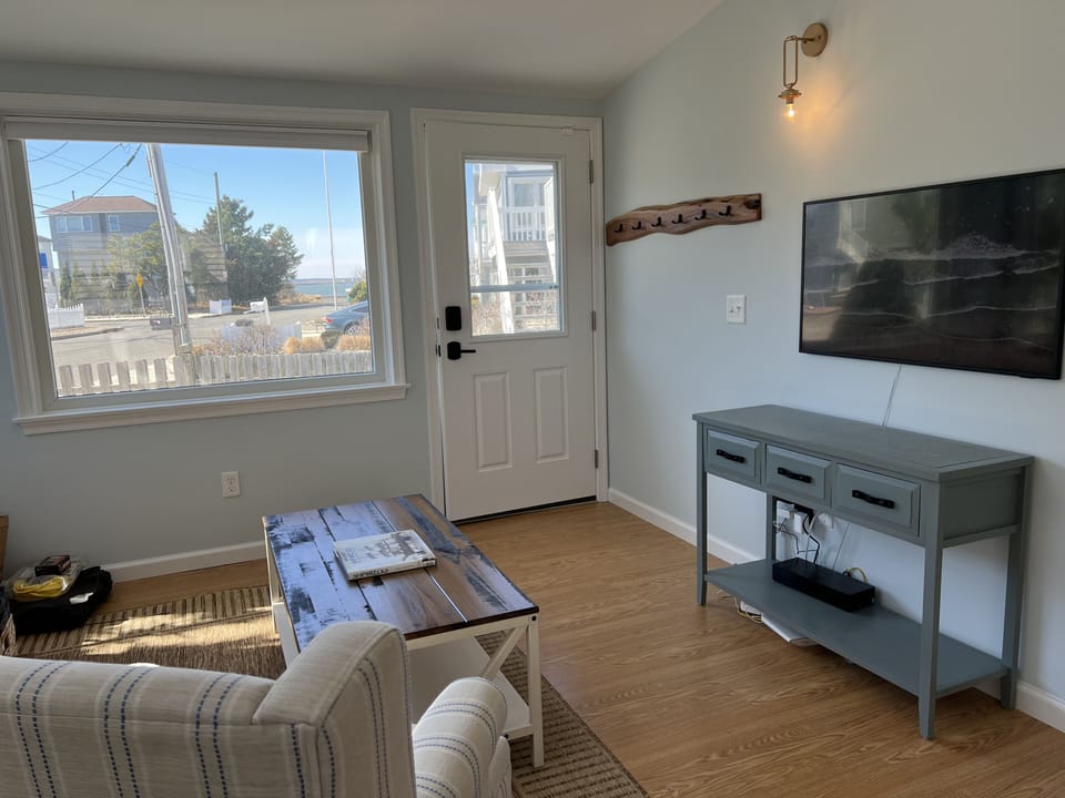Living room with picture window and perfect sunset views over the bay