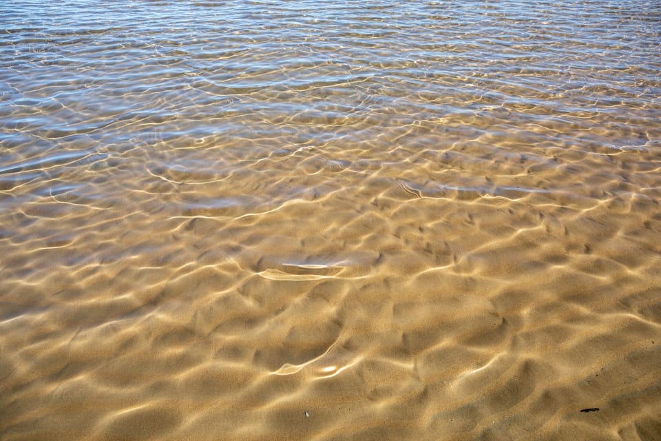 The water is so crystal clear that you can see the sandy bottom!