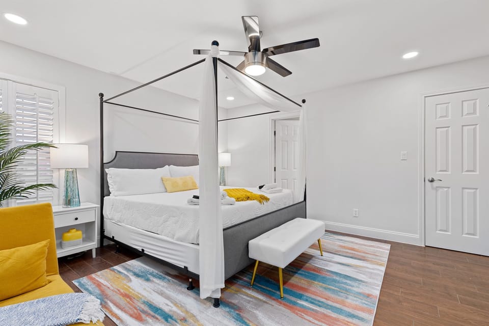 Retreat to the Master Suite, featuring a king sized bed and a relaxing chaise longue.
