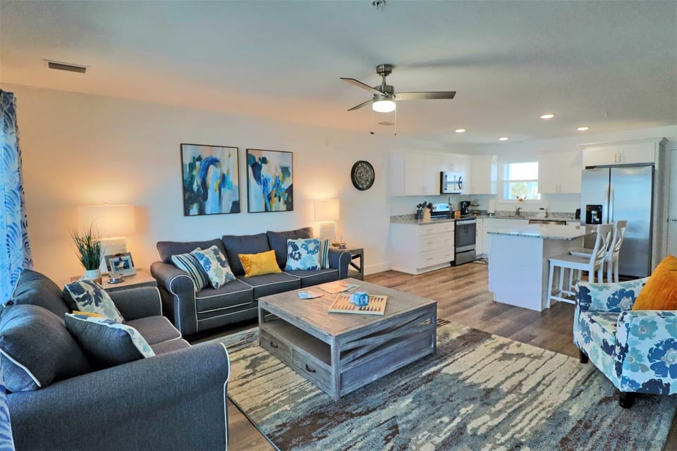 As you enter the home, you are greeted with a warm coastal vibe and modern decor