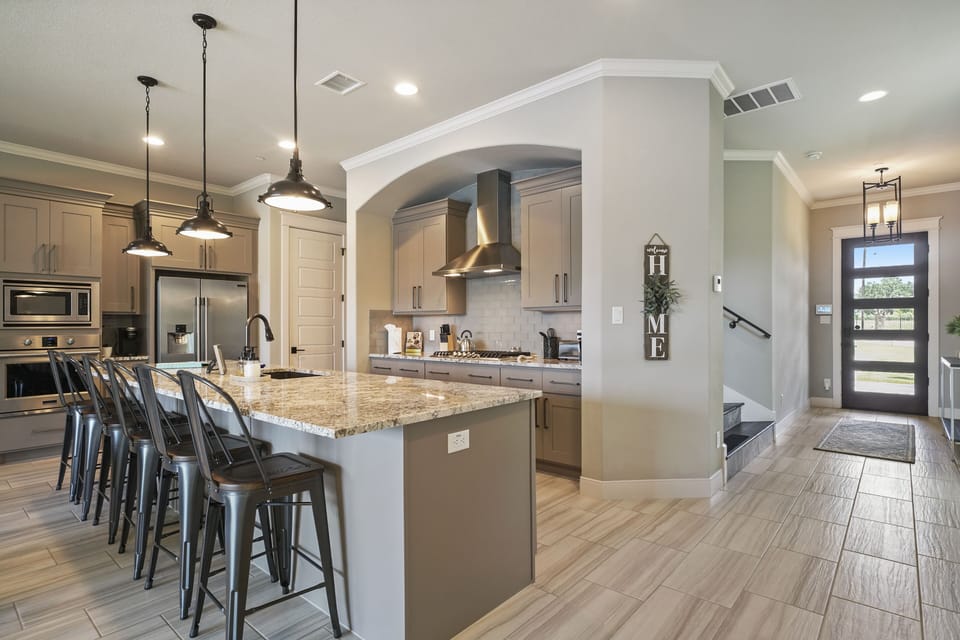 large island with seating, gas stove. 