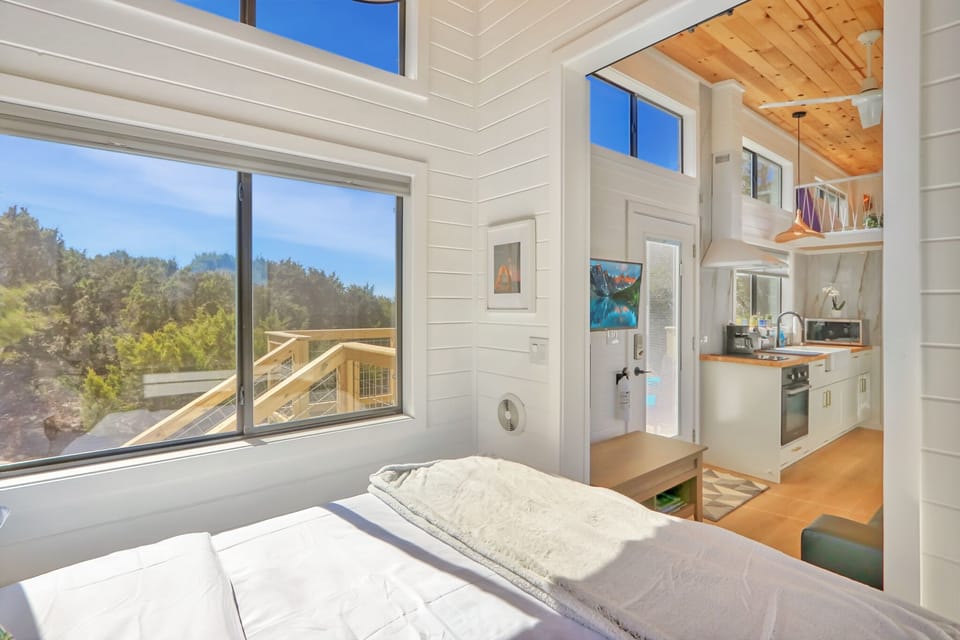 Looking out the bedroom entrance. The front door can be seen as well as the living room television.