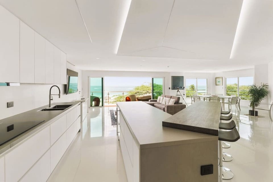 The fully equipped kitchen area and dining area open onto the entertaining living room, setting the stage for many memorable evenings. Plenty of natural light coming through large sliding balcony doors directly overlooking Eagle Beach.