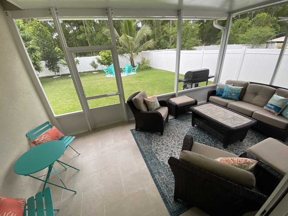 Covered, screened-in back patio area.