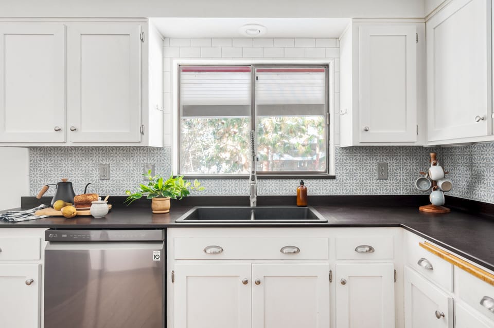 Kitchen houses modern appliances.