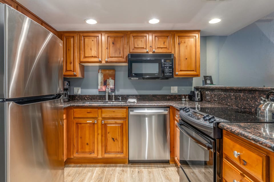 Fully Equipped Kitchen with stone countertops, GE appliances, and bar seating for two