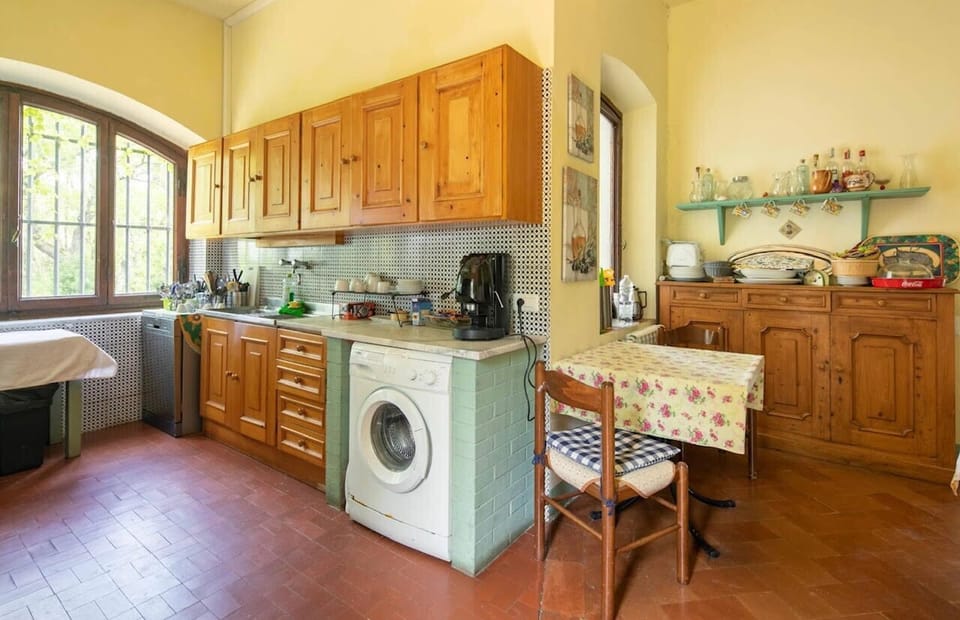 Traditional Tuscan kitchen ample cabinetry, and beautiful garden views f