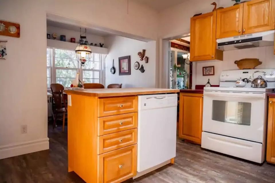 Fully stocked kitchen lined with decor and includes a breakfast nook. 
