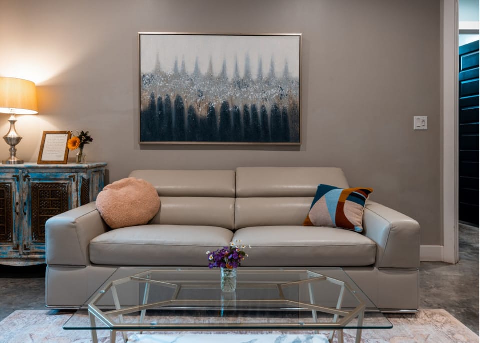 Sitting area in the primary bedroom includes a sofa bed that folds out into a queen and coffee table