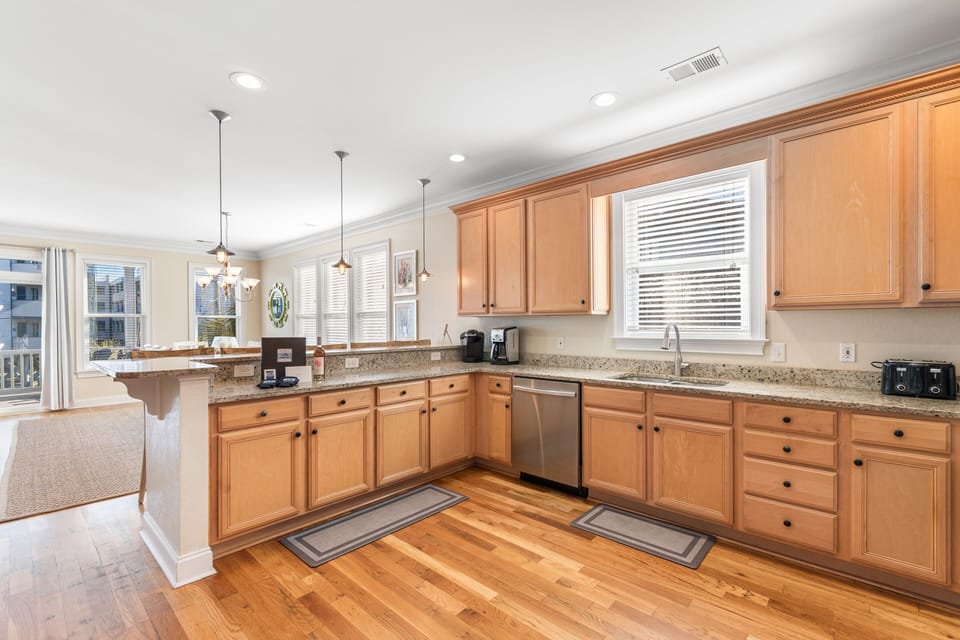 Cook your favorite meals in this spacious kitchen with granite counters, warm wood cabinets, and modern appliances.