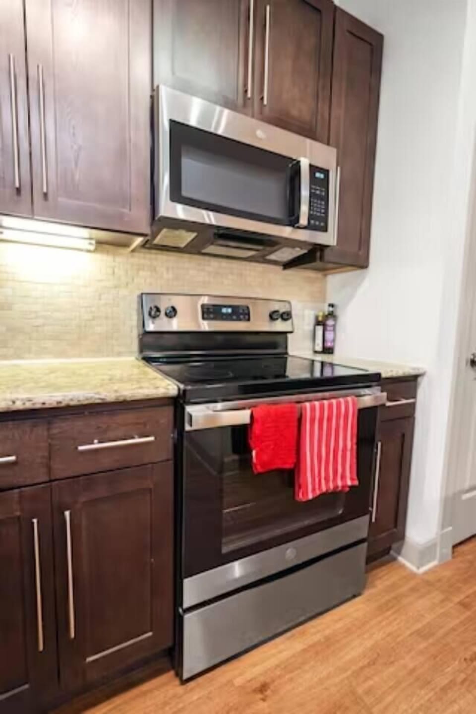 Prepare full meals on the stainless stove with microwave, pots, and utensils provided for your convenience.
