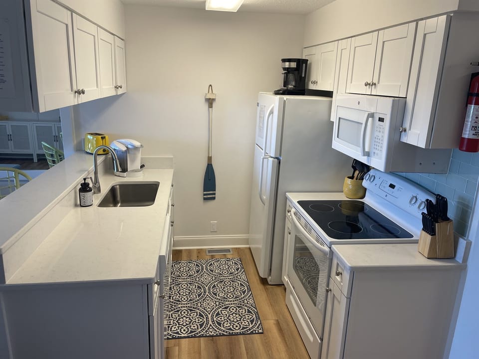 kitchen with new countertops with a keurig and regular coffee pot.