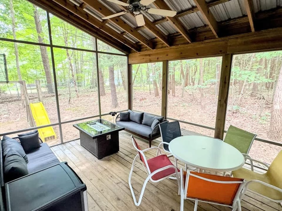 With lounge seating around the fire table, a colorful spot for games or snacks, and a front-row view of the backyard play space, this screened-in porch is where your days begin and end.