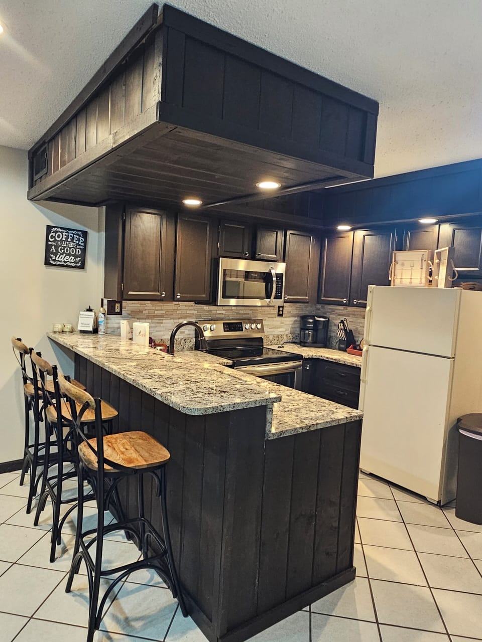 Kitchen with pots, pans, utensils. & keurig coffee machine. Icebox with icemaker
