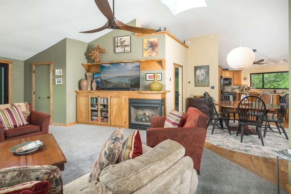 Great room with TV open to dining room/kitchen.