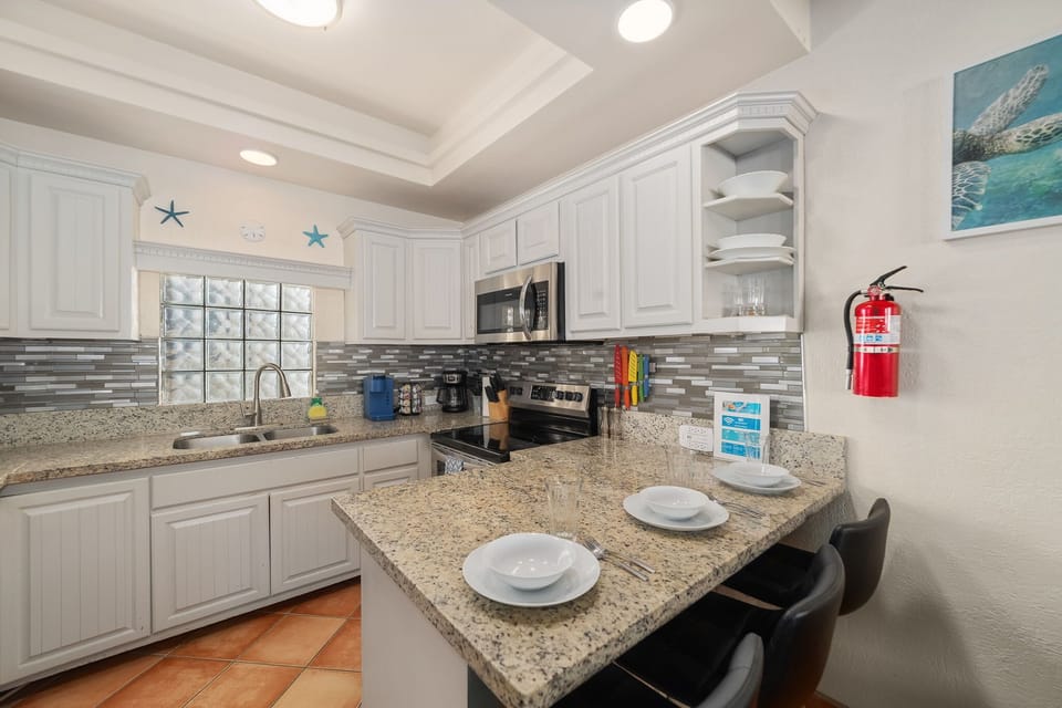 Features granite countertops, stainless steel appliances, bar seating for two, and all the essentials to cook or entertain during your stay.