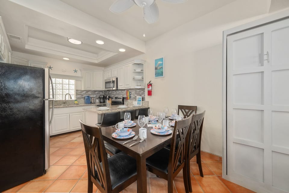 Classic Saltillo tile floors and vibrant art add charm and character to this inviting space.