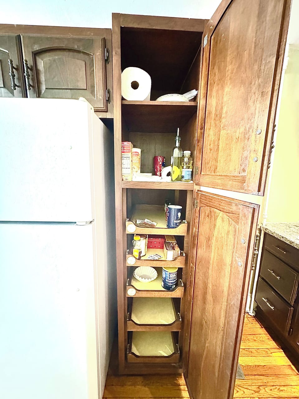 Kitchen cabinet with basics (salt, pepper, olive oil, vegetable oil, coffee, etc